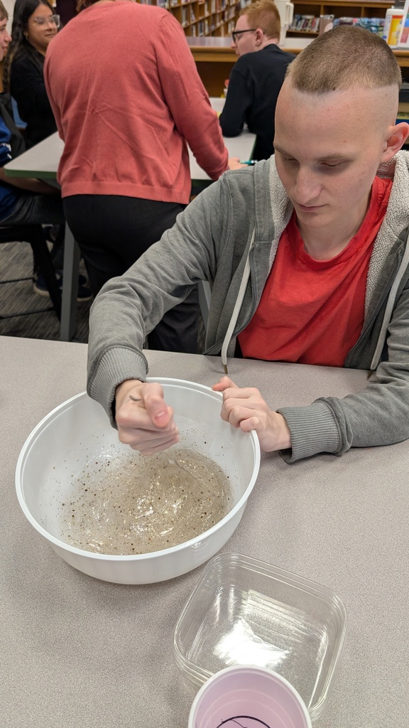 Students investigating slime
