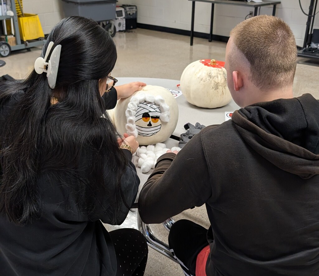 TILT students decorating pumpkins together