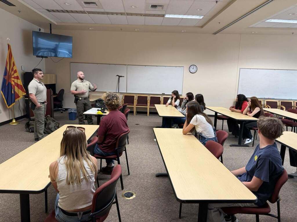 Students listening to detectives about what it is to be in law enforcement