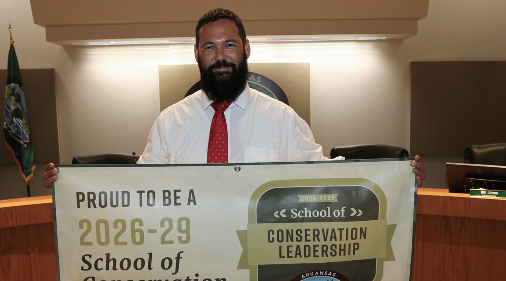 Coach James Realon receives AGFC School of Conservation designation.