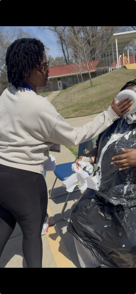 Ms. Walker: "Hold my clipboard, I’ve got this." 🥧💅 She just couldn't resist! Ms. Jackson was already a target, but Ms. Walker made sure the job was done right. Such a fun moment at KIPP Delta Elementary!