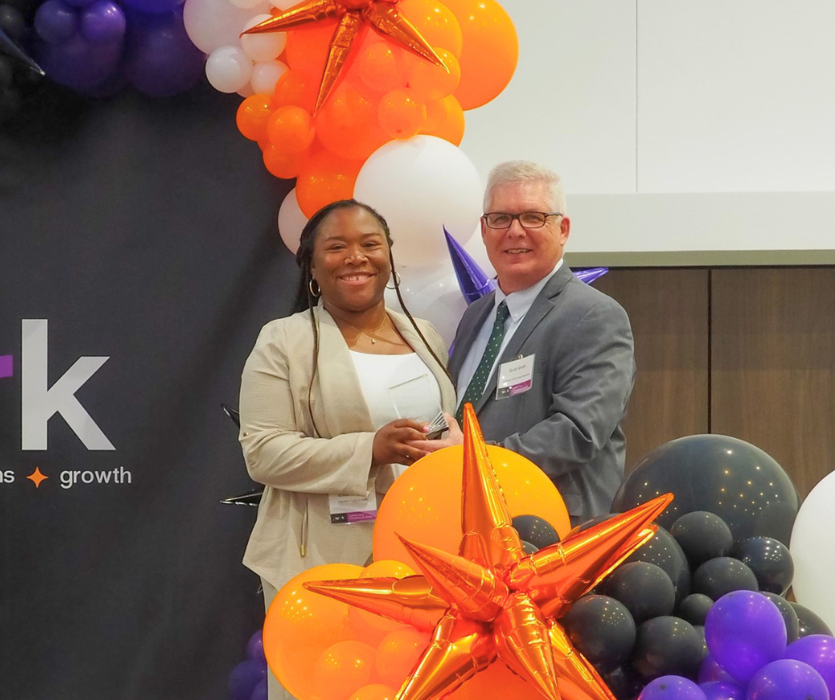 Erika Hubbard (BCPS Principal) receiving Elevate Award from Scott Smith (APSRC) at Spark2026 Symposium