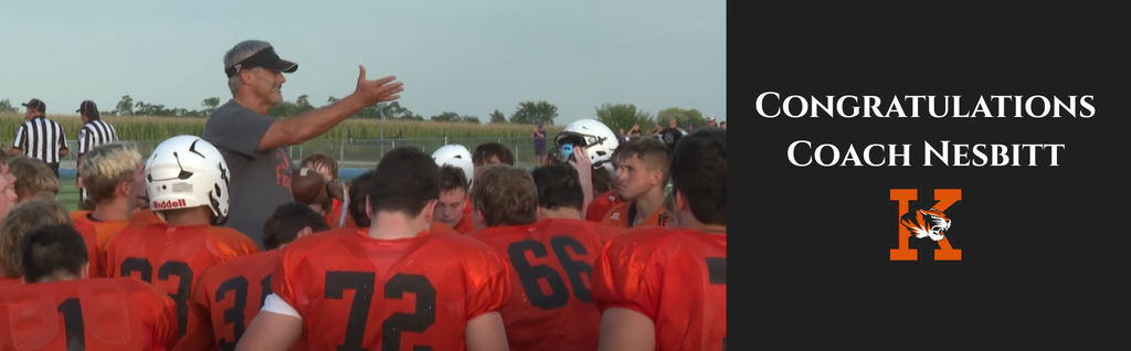Congratulations Coach Nesbitt banner with photo of him talking to football players.