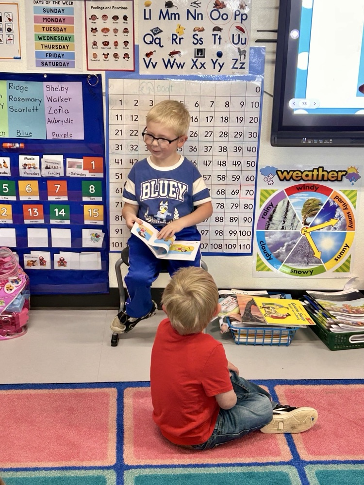 student reading aloud to class