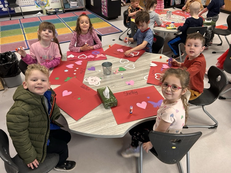 students working on a craft at table
