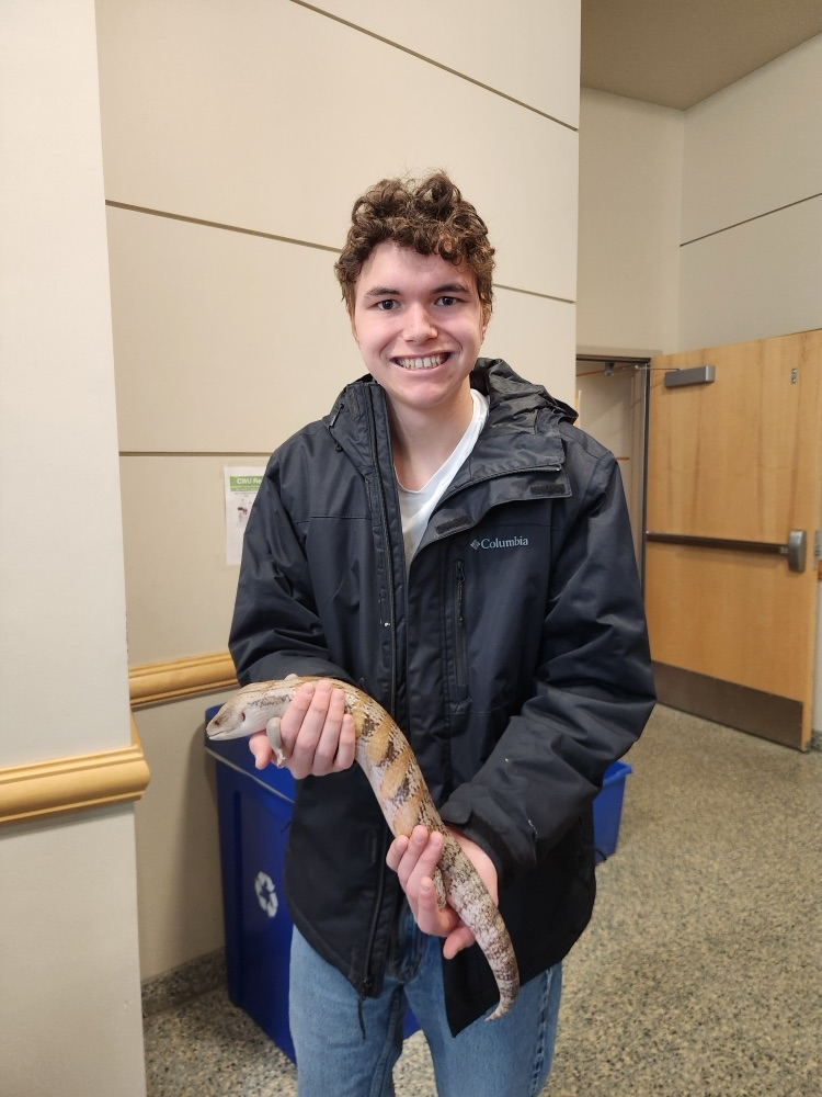 student holding reptile