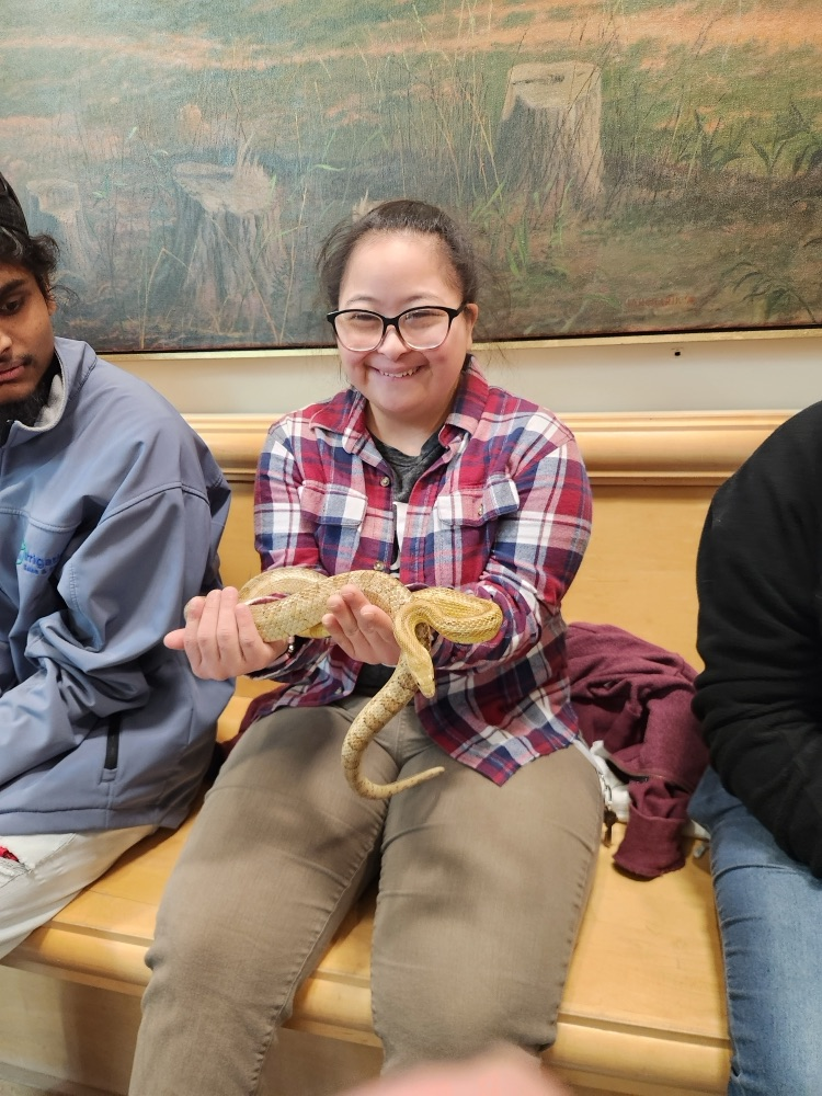 student holding reptile