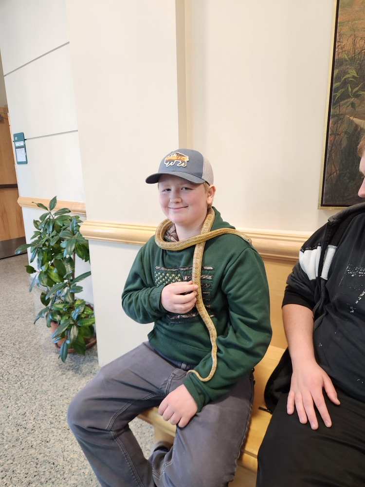 student holding reptile