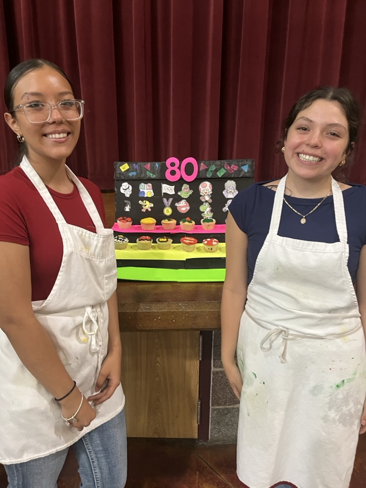 students showcasing cupcakes
