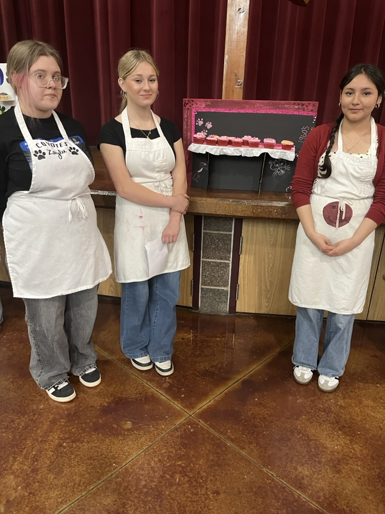 students showcasing cupcakes