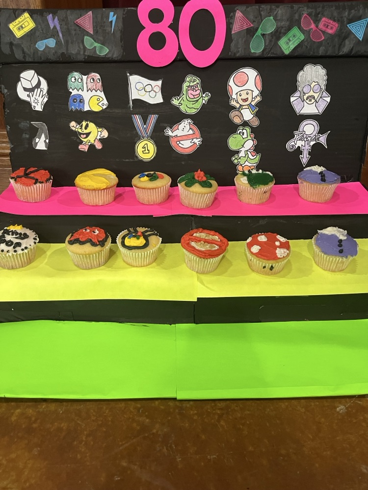 students showcasing cupcakes