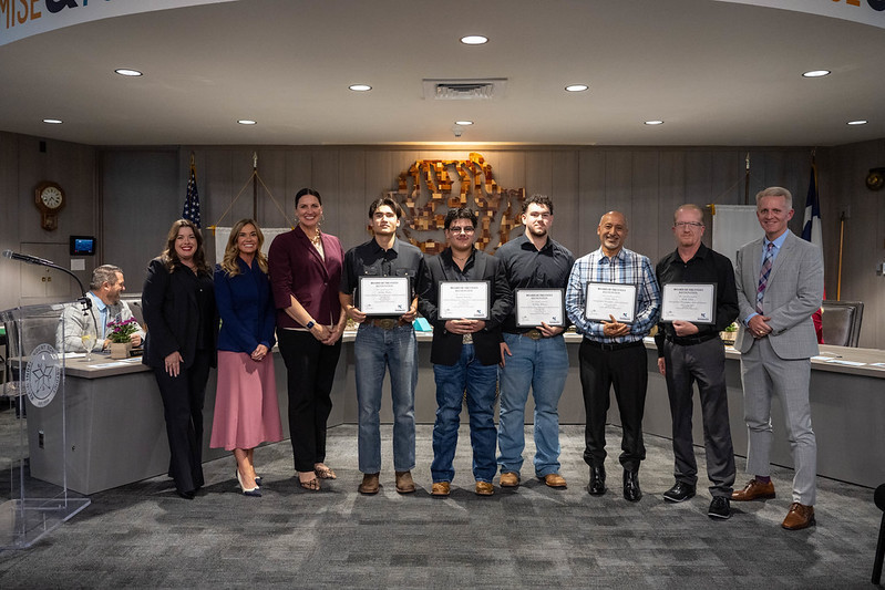 students posing with certificates 
