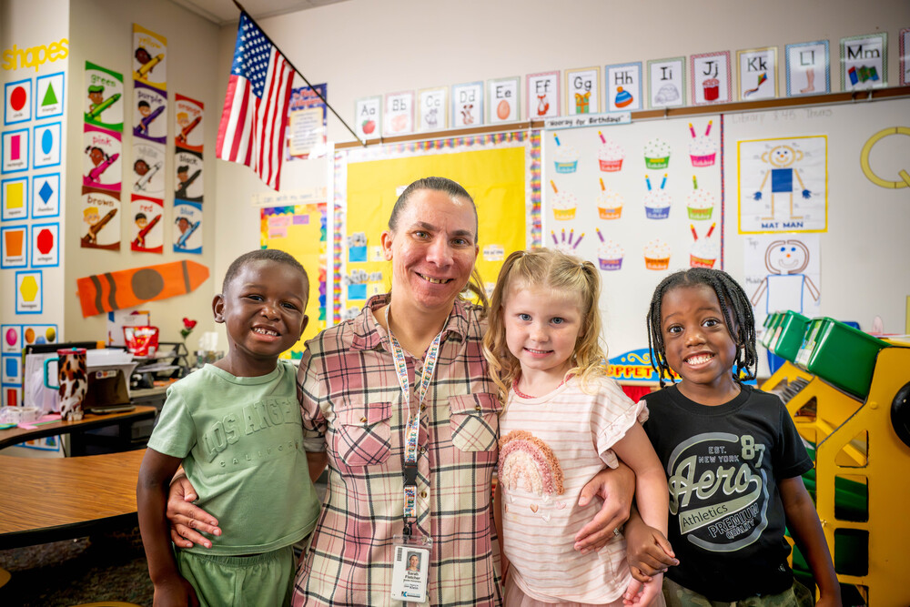 Sarah Fletcher posing with three students