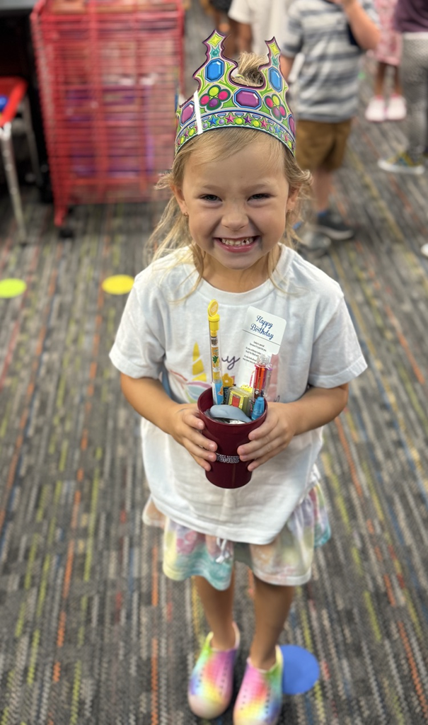 student with birthday cup