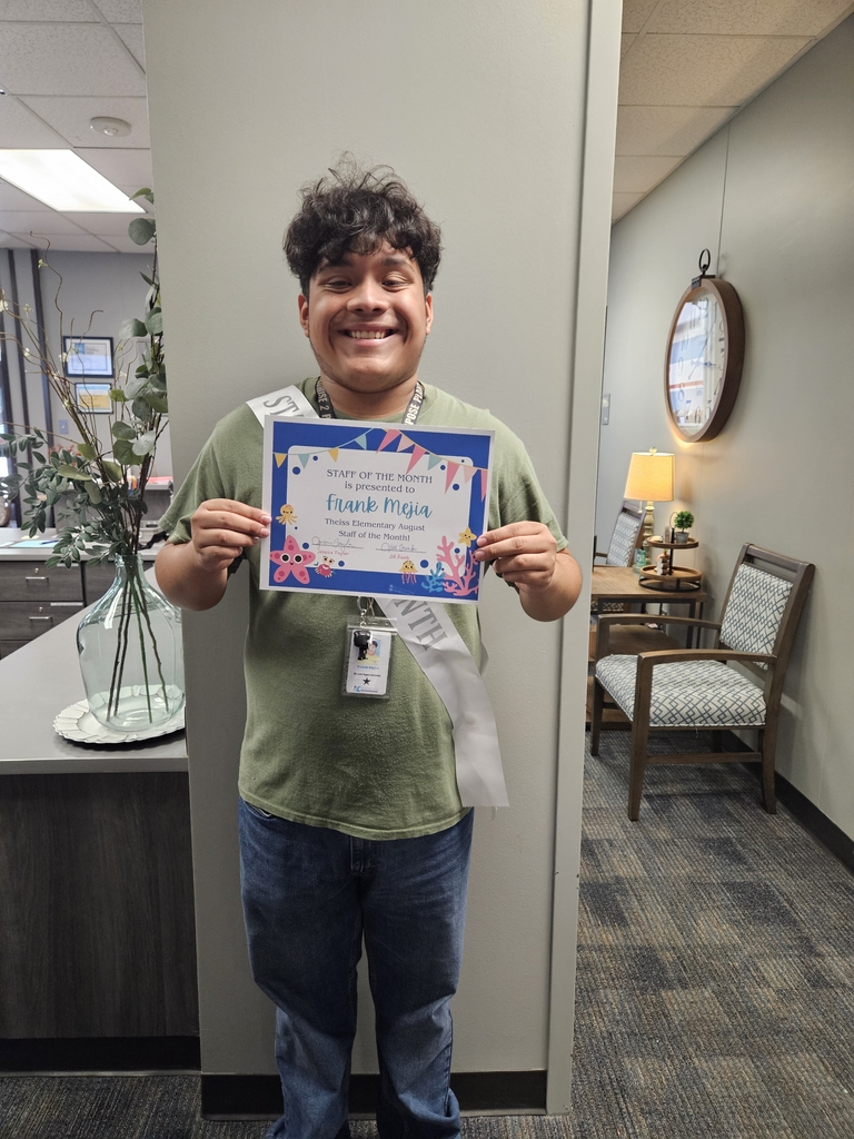 male custodian holding a certificate for Staff of the Month