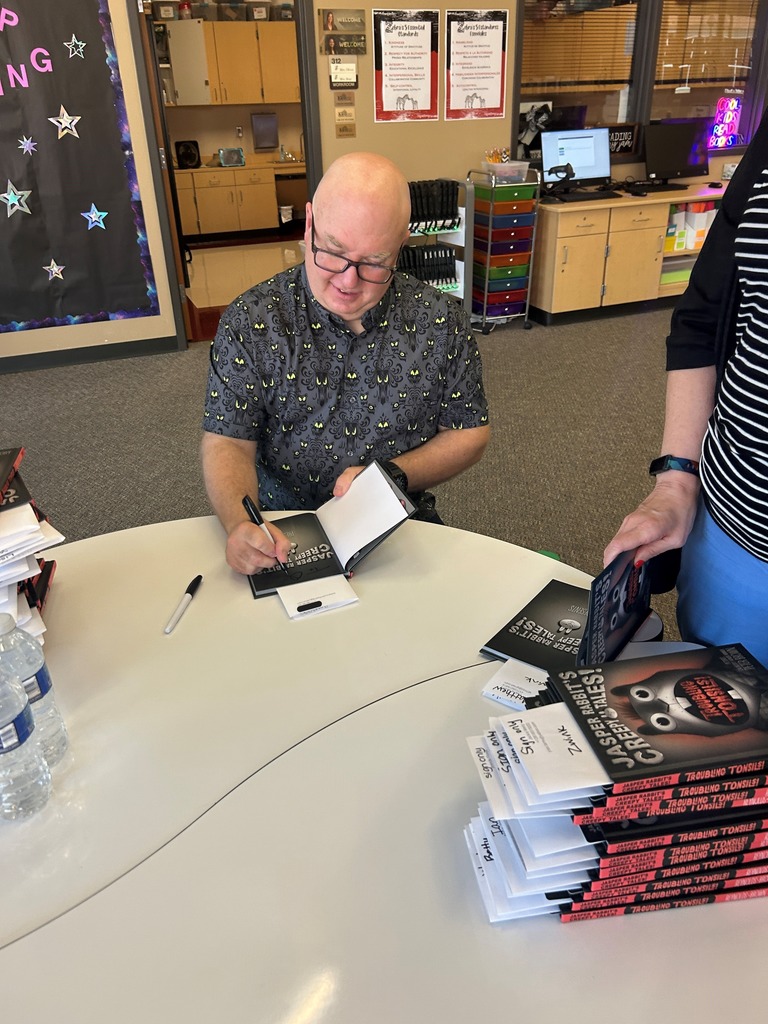 Aaron Reynolds signing books for students