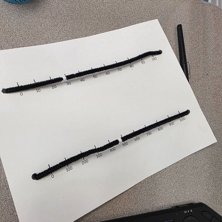 white paper with black lines for numbers 