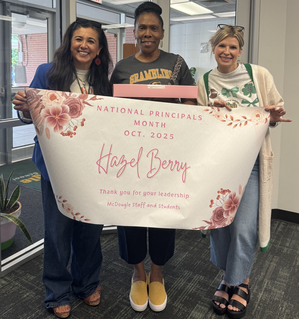 3 women holding a banner, box of cookies and smiling