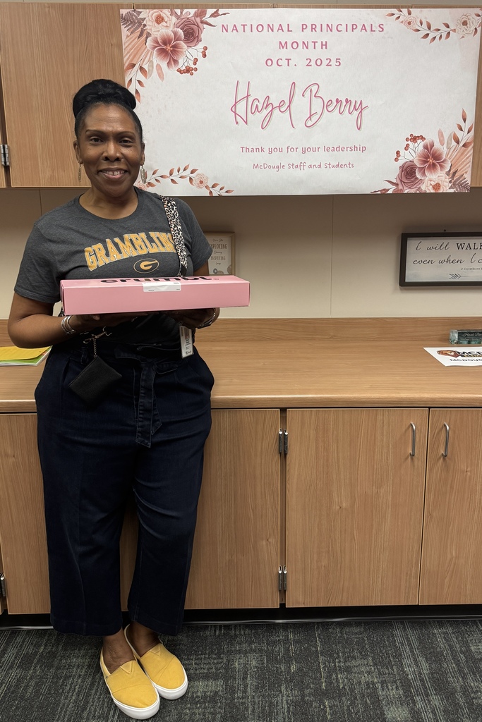 Mrs. Berry with her sign and cookies