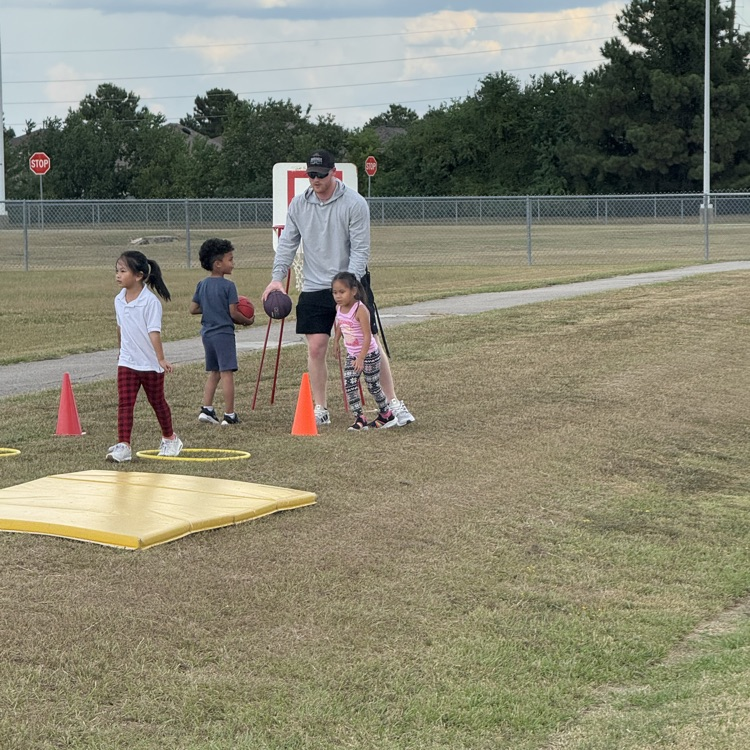 PE teacher with cones and 3 students