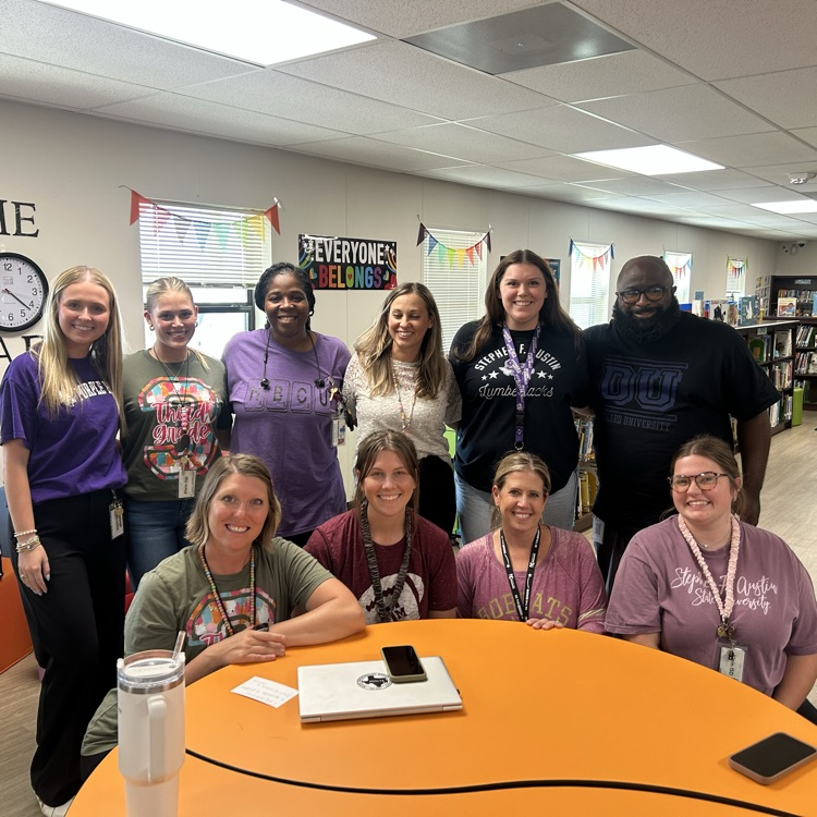 LTaCs and teacher residents pictured in library at orange table