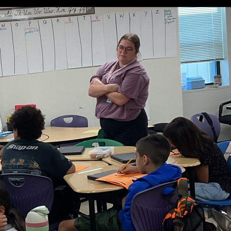 resident actively monitoring student work progress as a student- led instruction