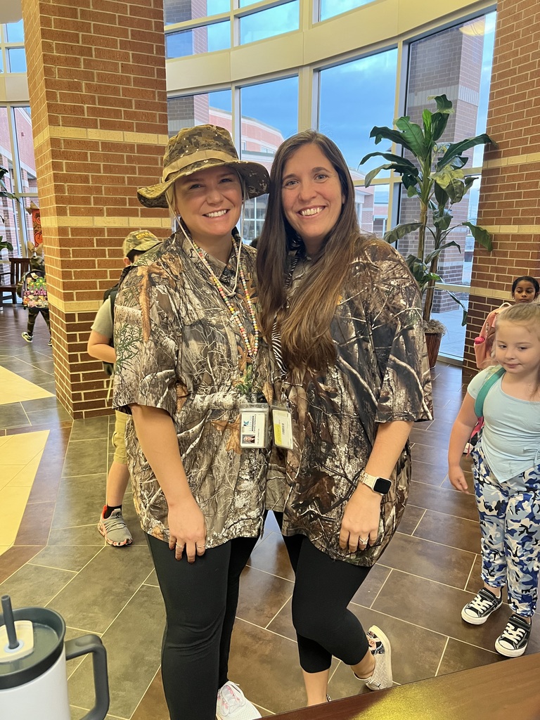 Two teachers pose for camo day