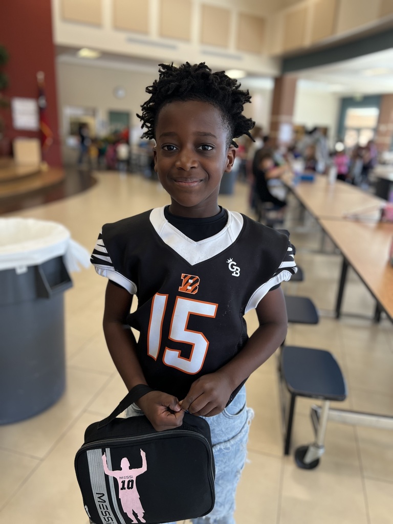 Student poses for team shirt day