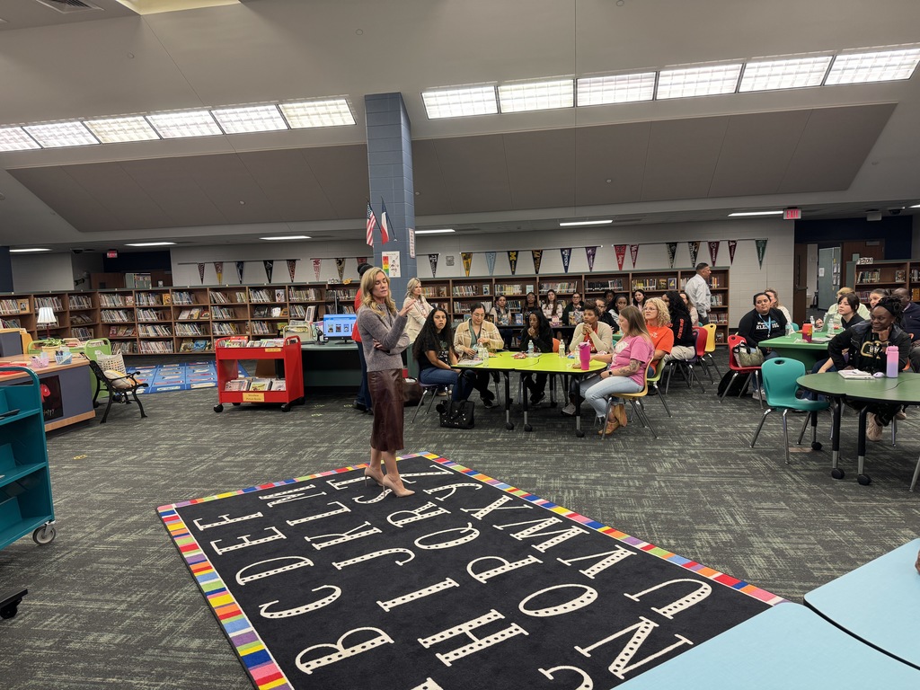 Women speaking to a group of educators