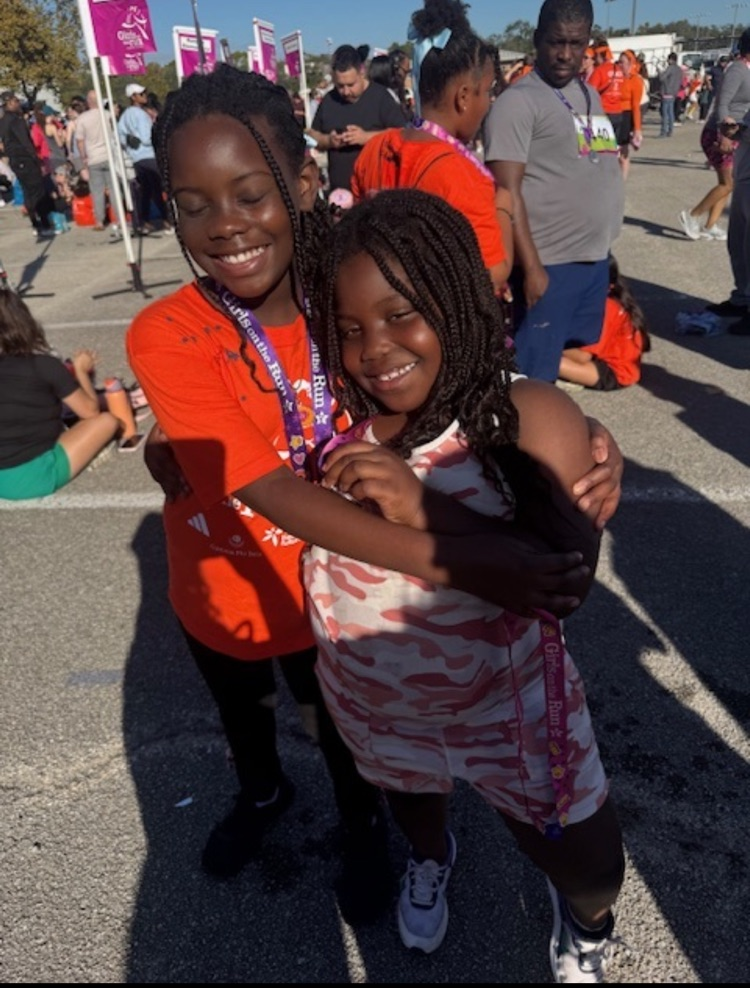 2 girls proud of finishing the race.