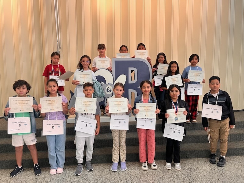 spelling bee contestants holding up their certificates
