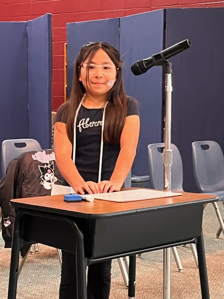 student standing in front of a microphone
