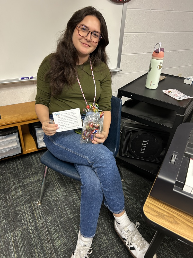 women in green shirt sitting.