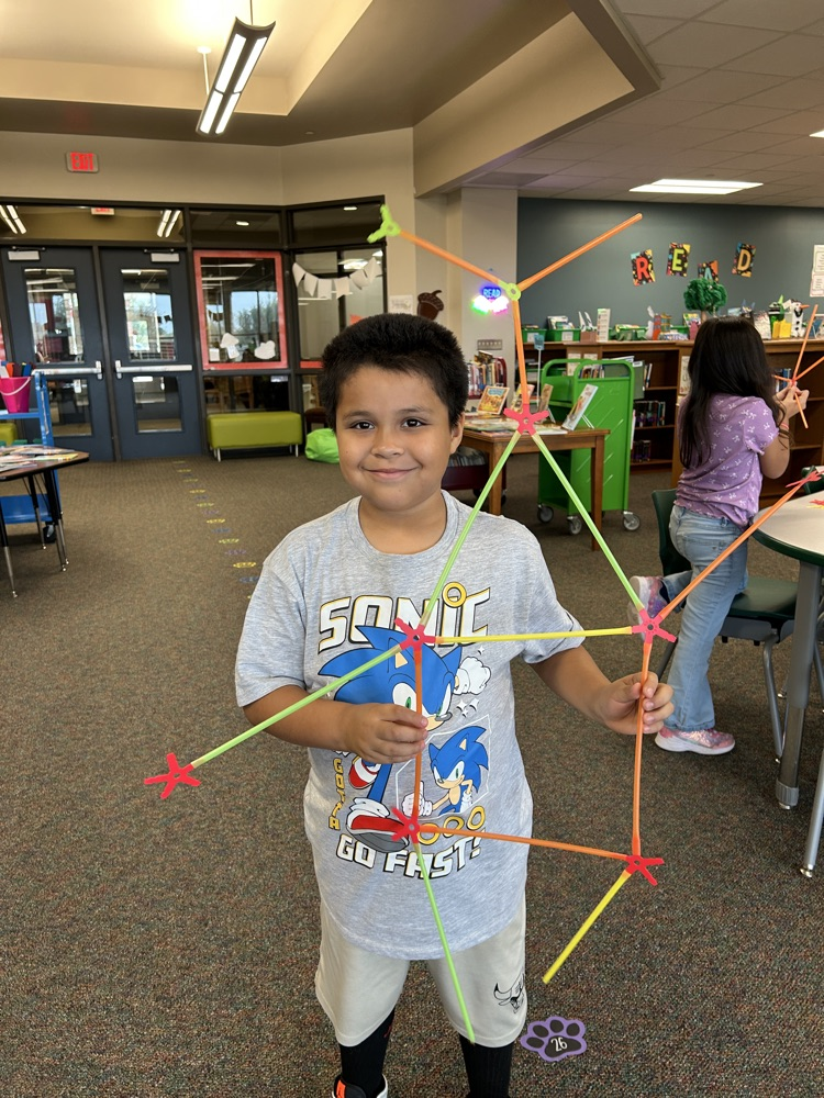 student using strawbees to build a person