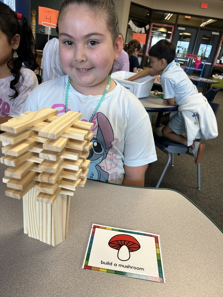 a student using keva blocks to make a mushroom
