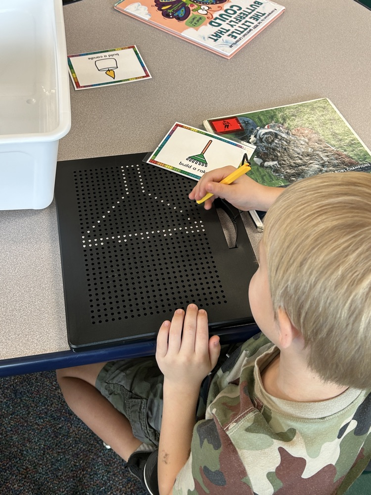a student using magnetic boards to draw a rake