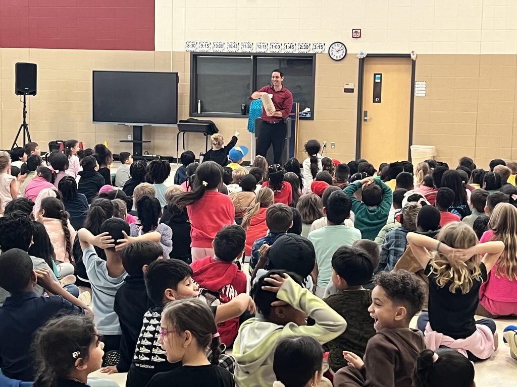 Magician performing trick in front of students