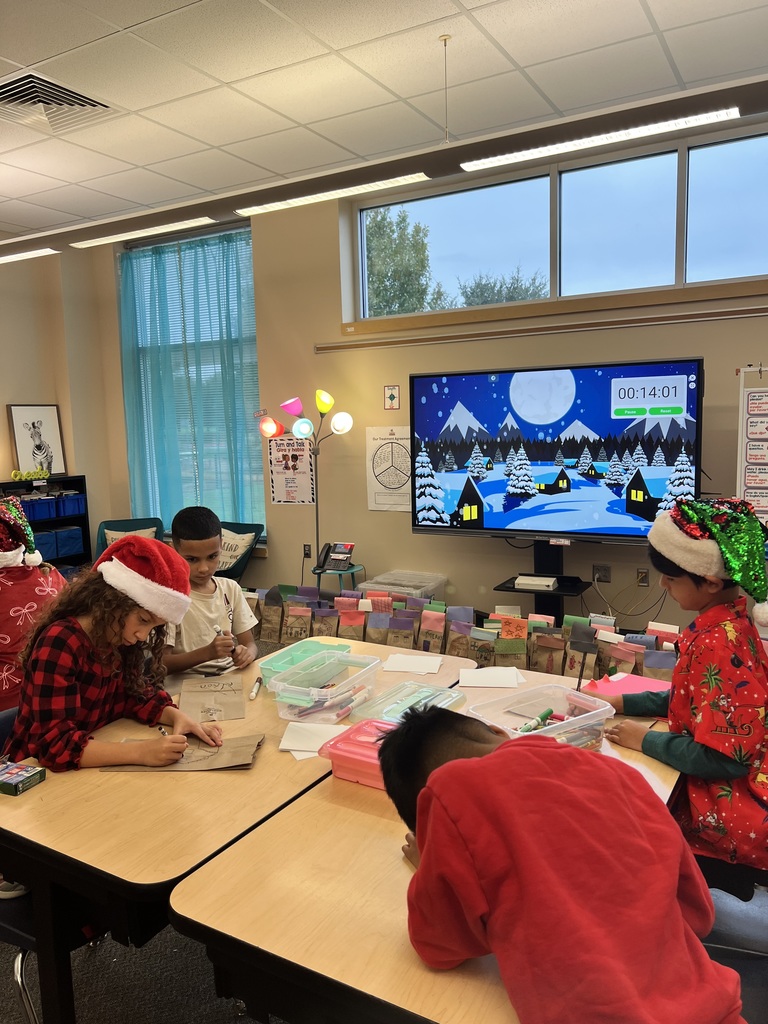 Four students coloring at desk