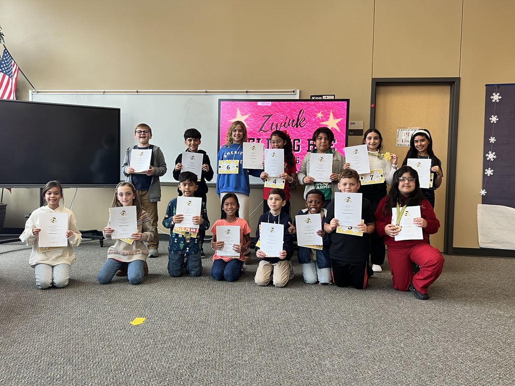 Top 15 spelling bee participants holding their certificates