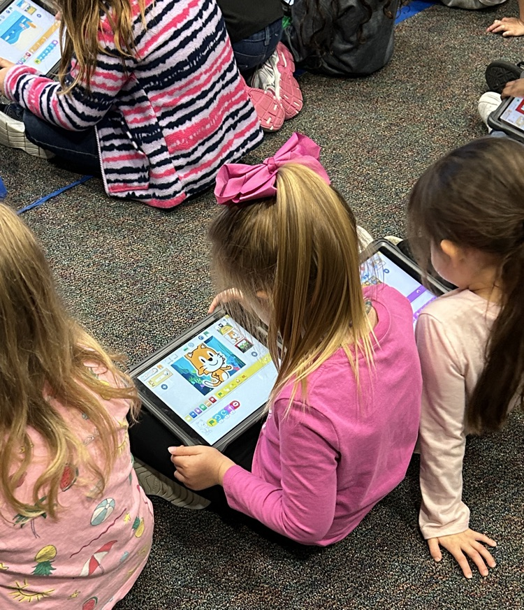kindergartners learning about Scratch Jr on iPads 