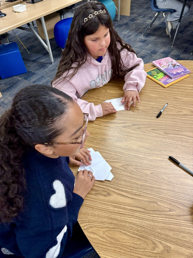 students creating origami