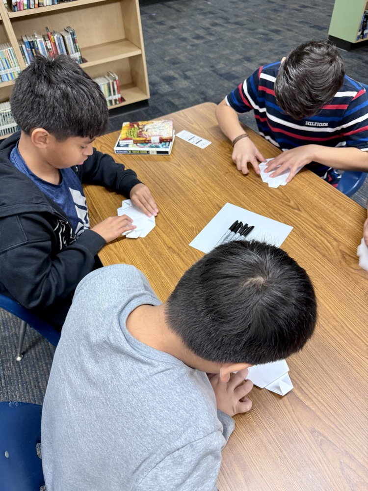students creating origami