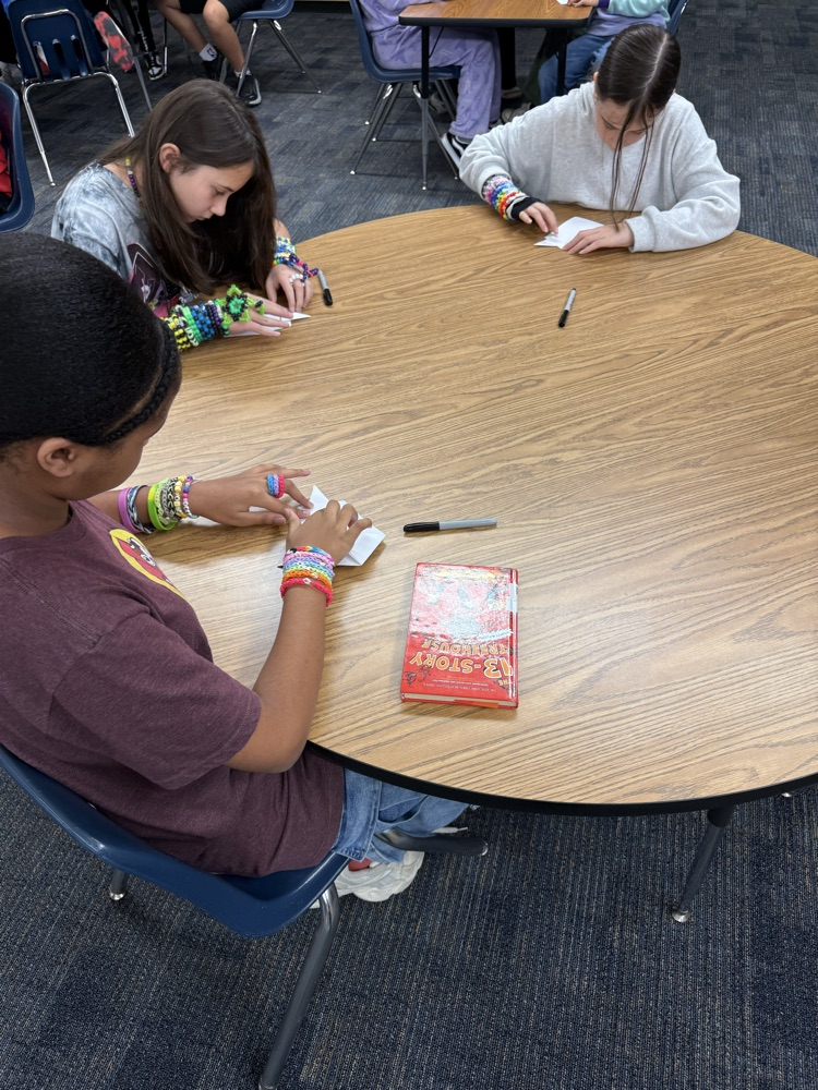 students creating origami
