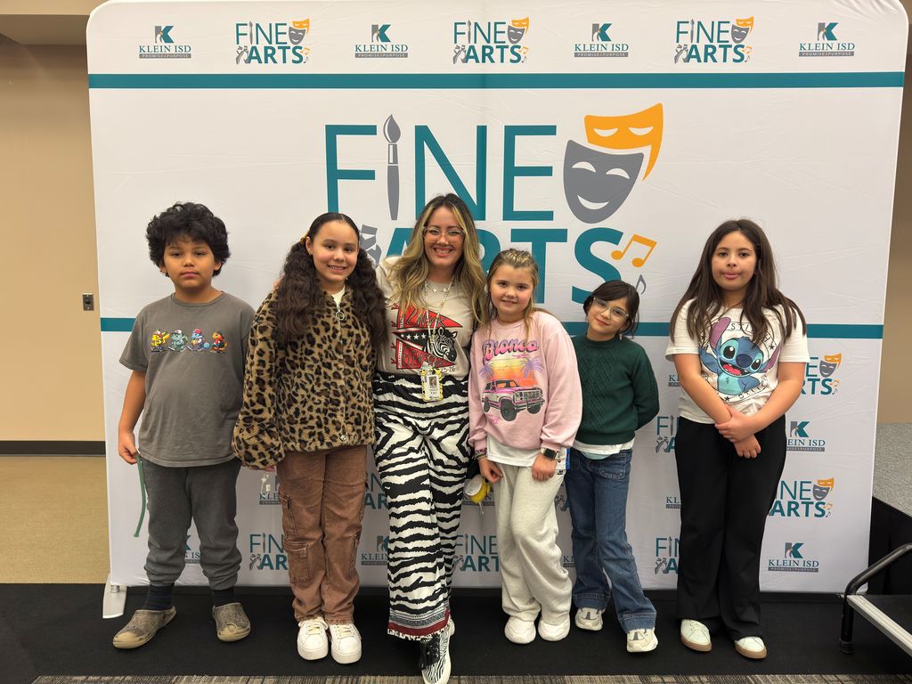 Students posing with art teacher