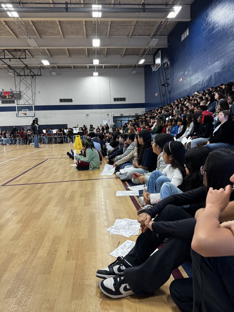 Group of students sitting on the floor.