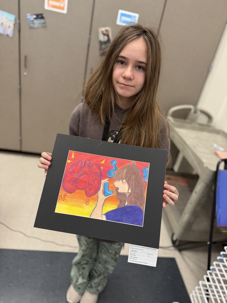 Student holding their artwork.