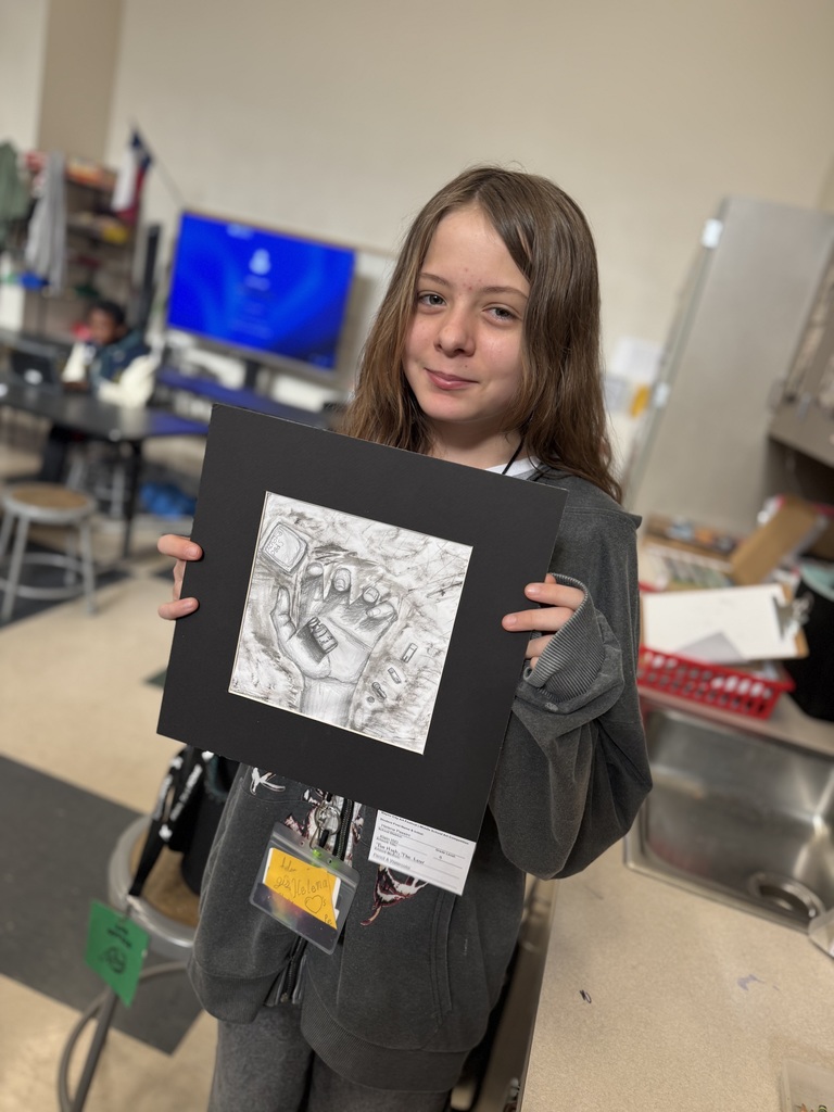 Student holding their artwork.