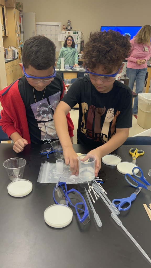 Students measuring substances for science experiment