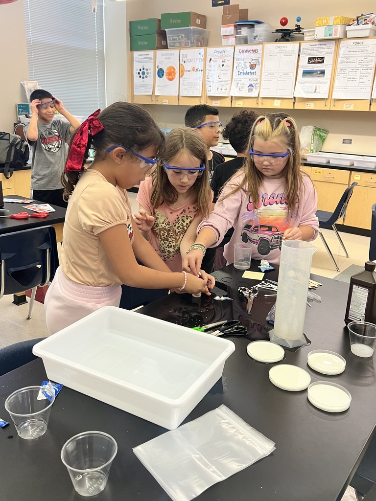Three female students conducting a science experiment
