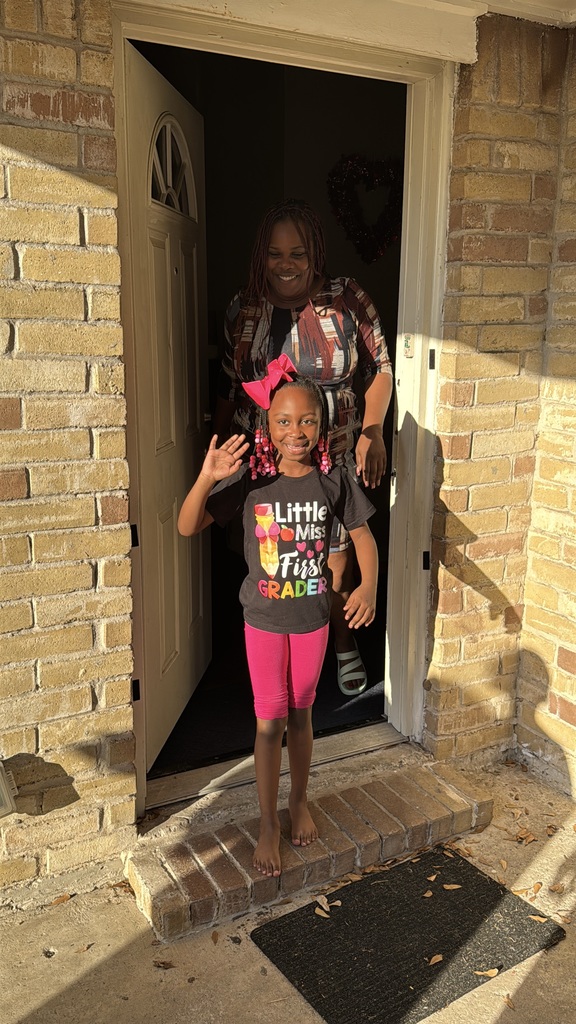 Student and adult walking out of front door